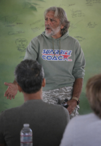 the image shows a motorcycle coach gives instructions in a classroom