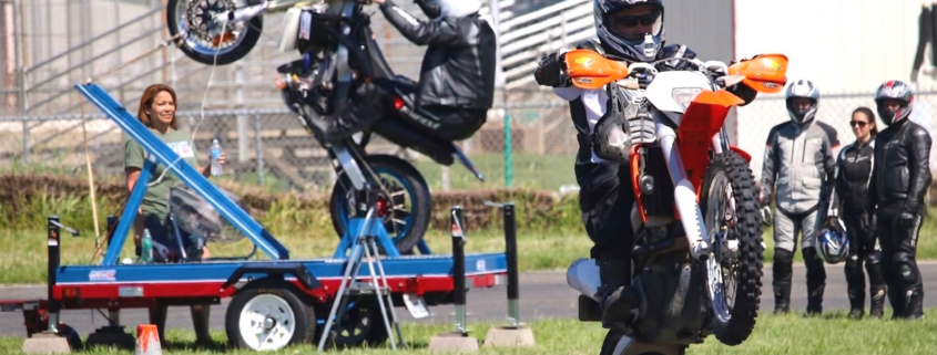 Image shows rider learning to wheelie at superbike-coach cornering class